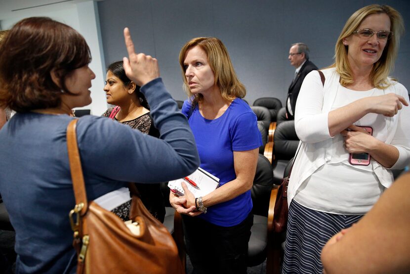 Richardson homeowner Melinda Hutchenrider (Center) visits with fellow homeowners who...