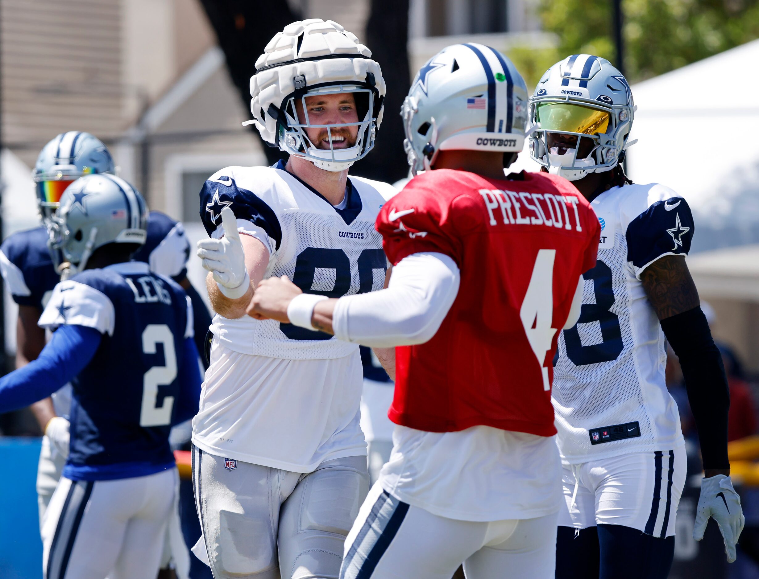 Dallas Cowboys quarterback Dak Prescott (4) congratulates tight end Dalton Schultz for...