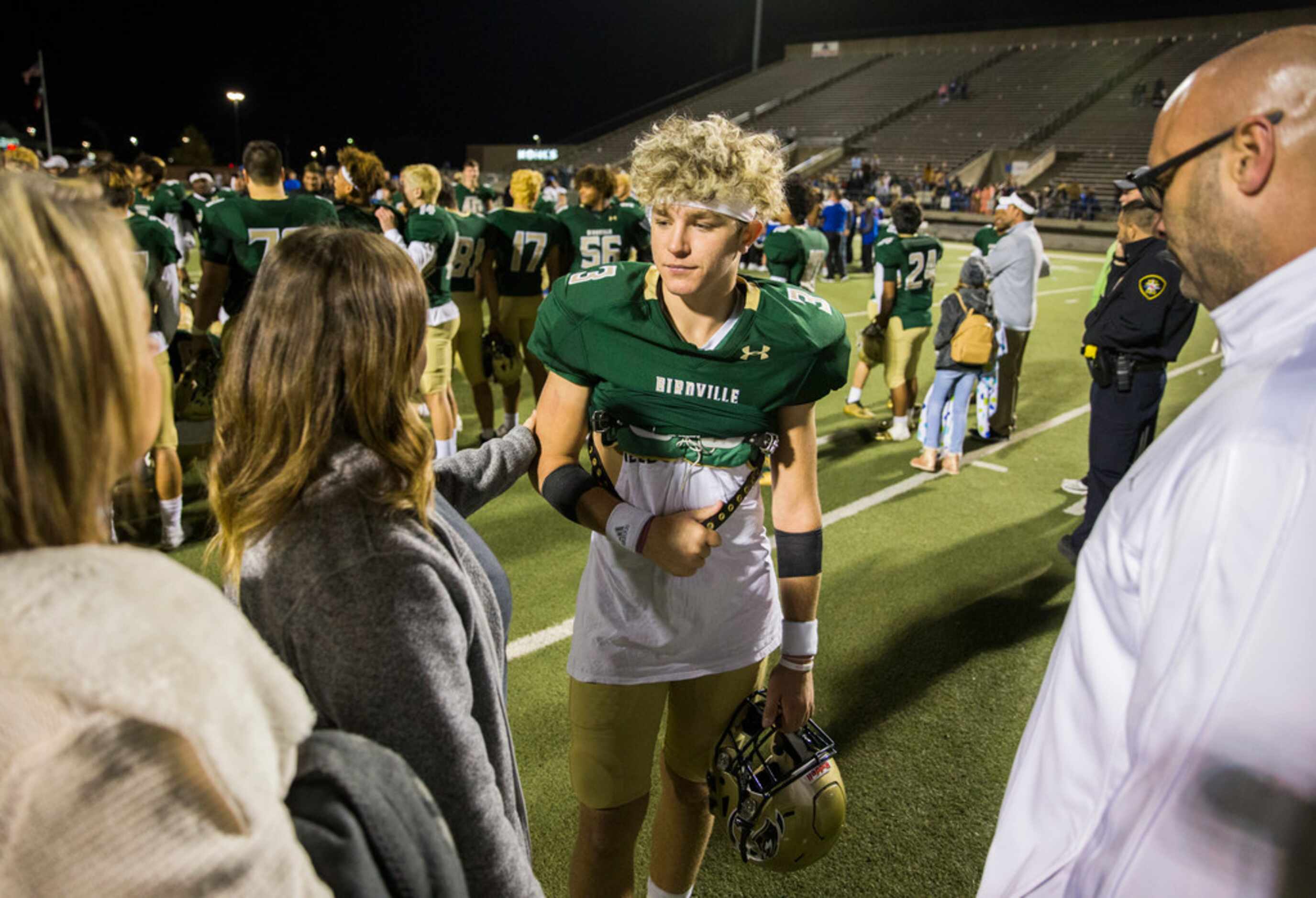 Birdville quarterback Stone Earle (3) greets his family after a 29-27 win over Fort Worth...