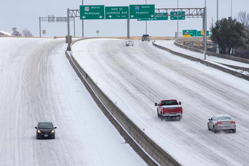 Snow covers Woodall Rodgers Freeway in Downtown Dallas on Monday. The snow has closed many...