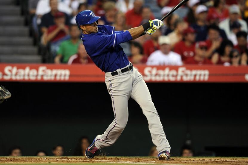 May 2, 2014; Anaheim, CA, USA; Texas Rangers right fielder Alex Rios (51) hits a single...