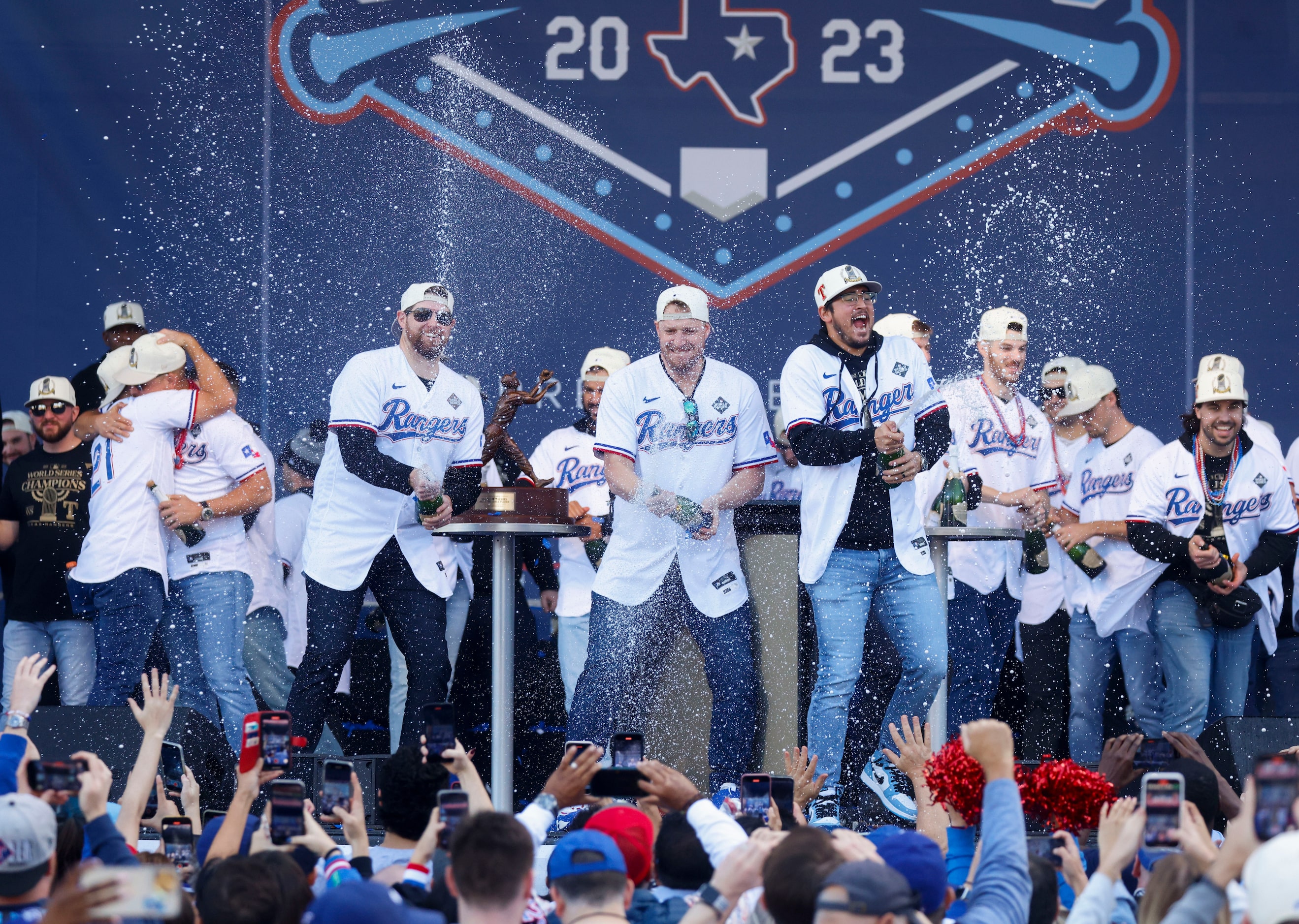 Texas Rangers players spray champagne during post-parade public celebration on, Friday, Nov....