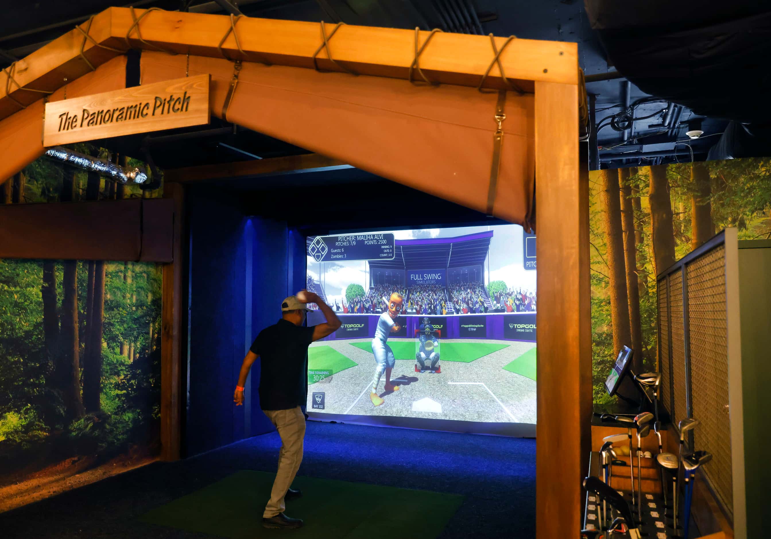 Shon Ali of Houston tosses a pitch in the Panoramic Pitch booth in The Grounds by TopGolf...