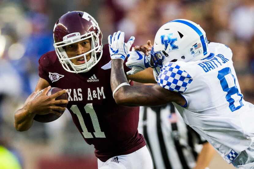 Texas A&M Aggies quarterback Kellen Mond (11) stiff arms Kentucky Wildcats cornerback...