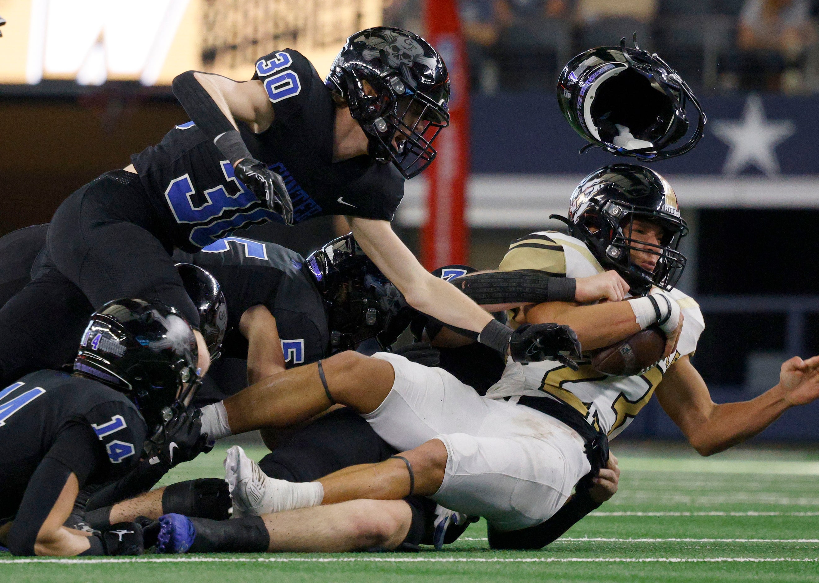 Woodville's Marquis Menefee (23) is tackled by Gunter's  Reid Brackeen (30), Gunter's ...