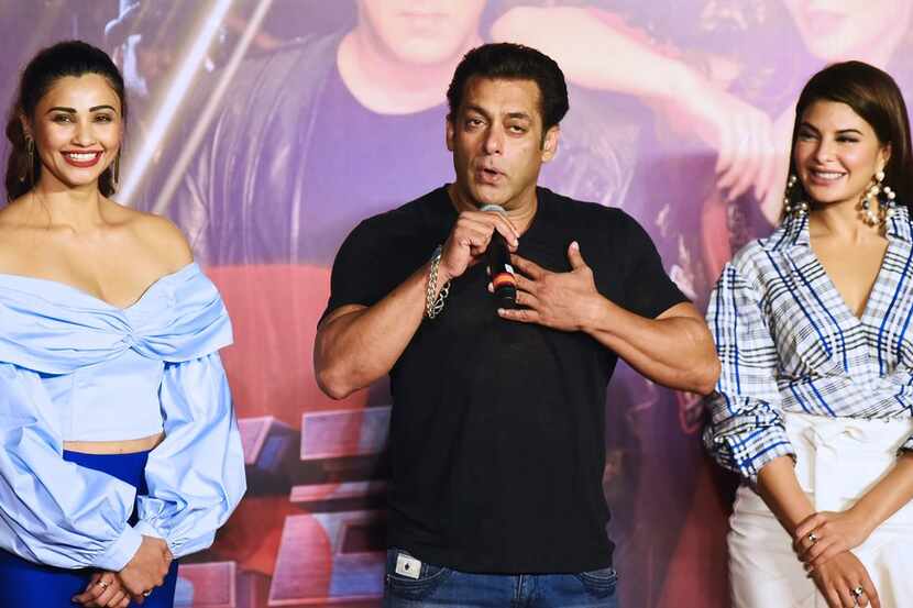 Indian Bollywood actor Salman Khan speaks next to actresses Jacqueline Fernandez (R) and...