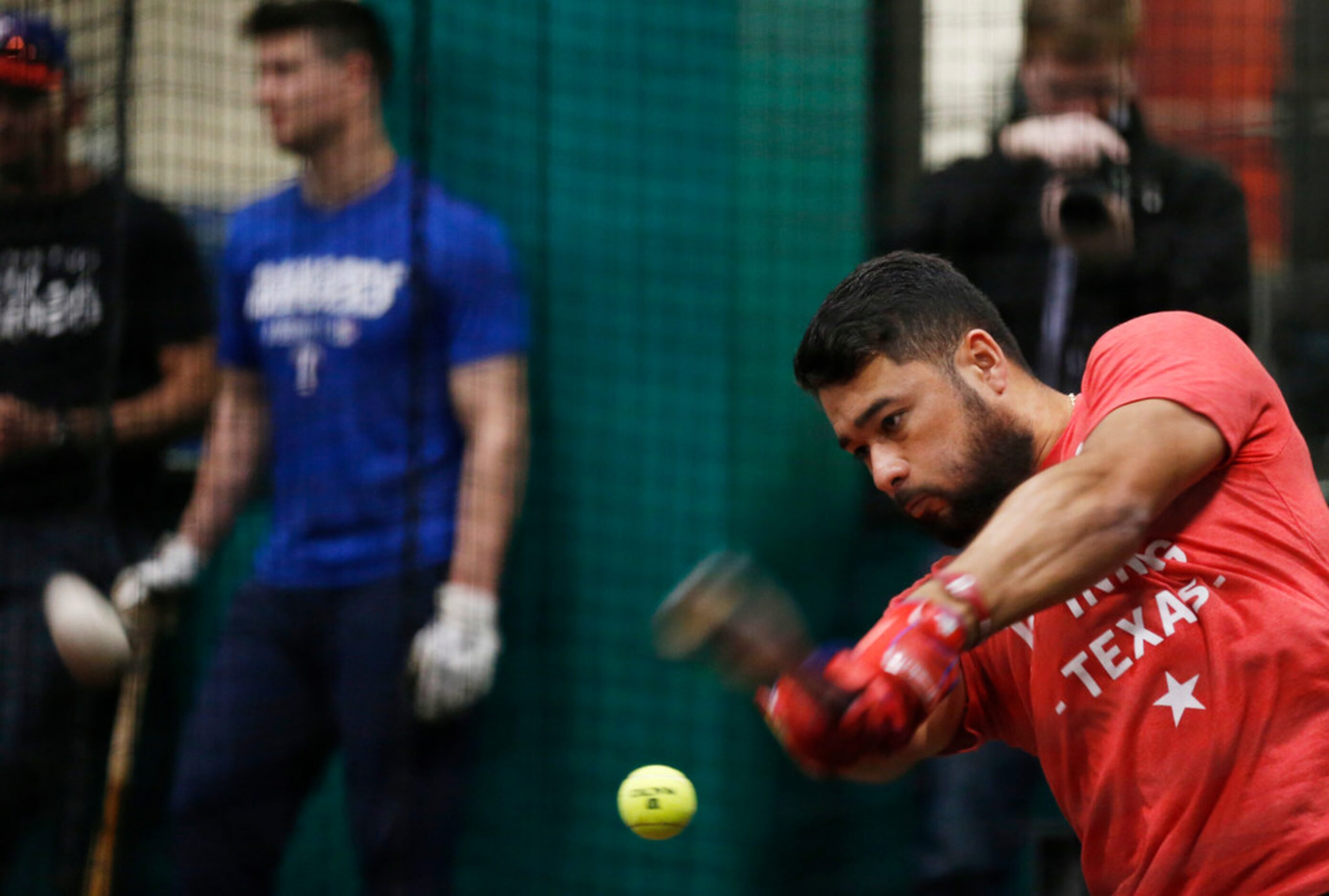 Texas Rangers Isiah Kiner-Falefa (9) uses a tennis ball as he works with Texas Rangers...