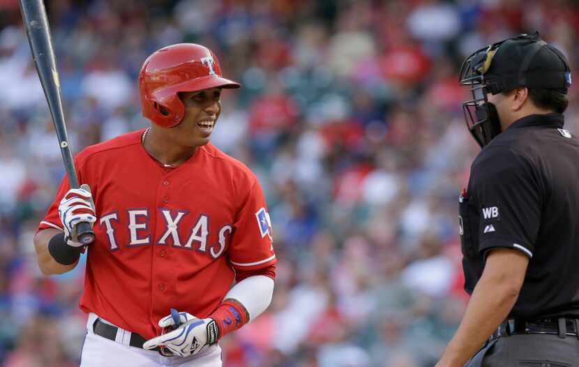 Texas Rangers Leonys Martin, left, reacts to a strike three call by home plate umpire Jim...