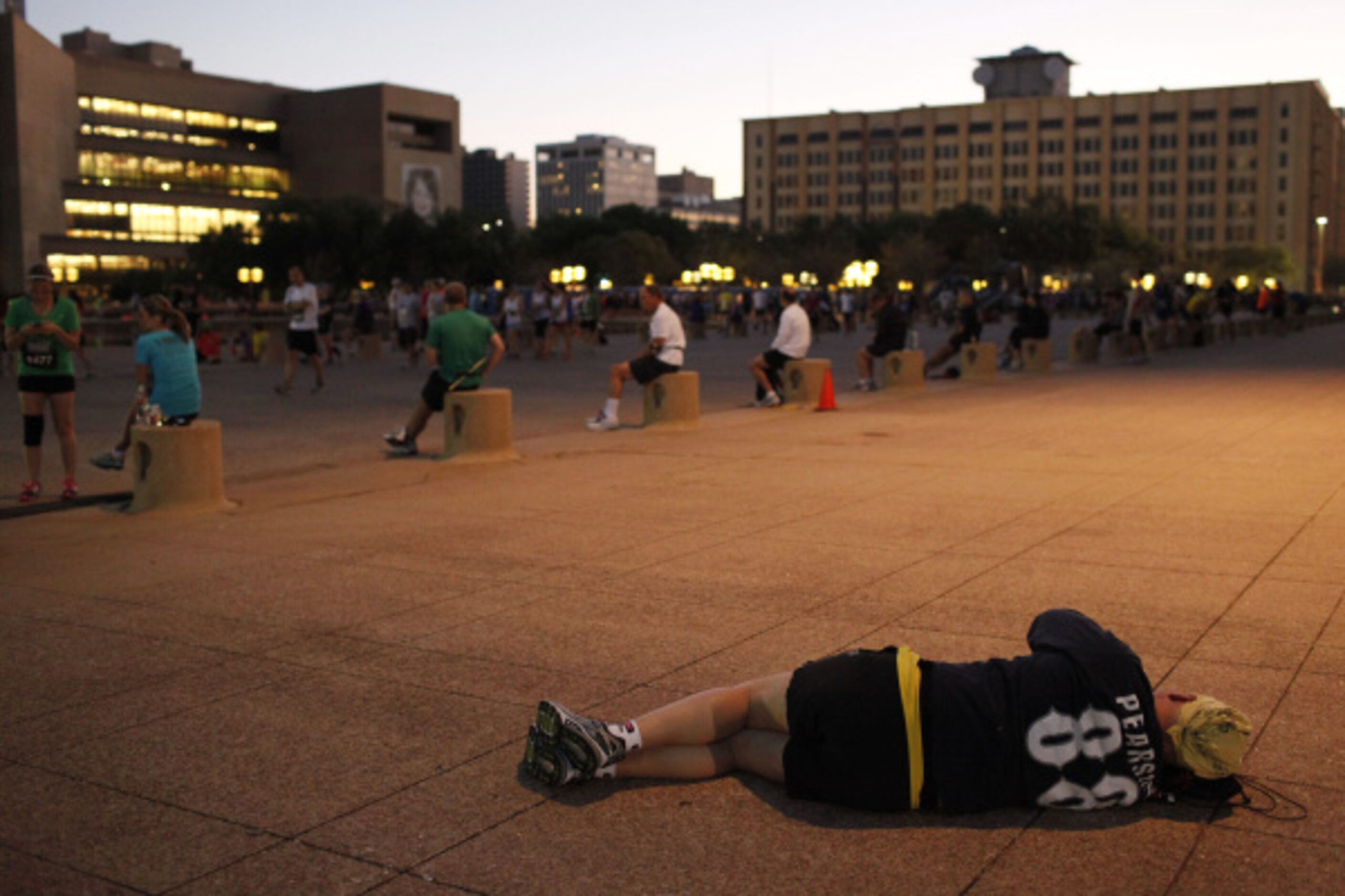 Ray Shoaf takes a quick nap before the Dallas Rock 'N' Roll half marathon begins on Sunday,...