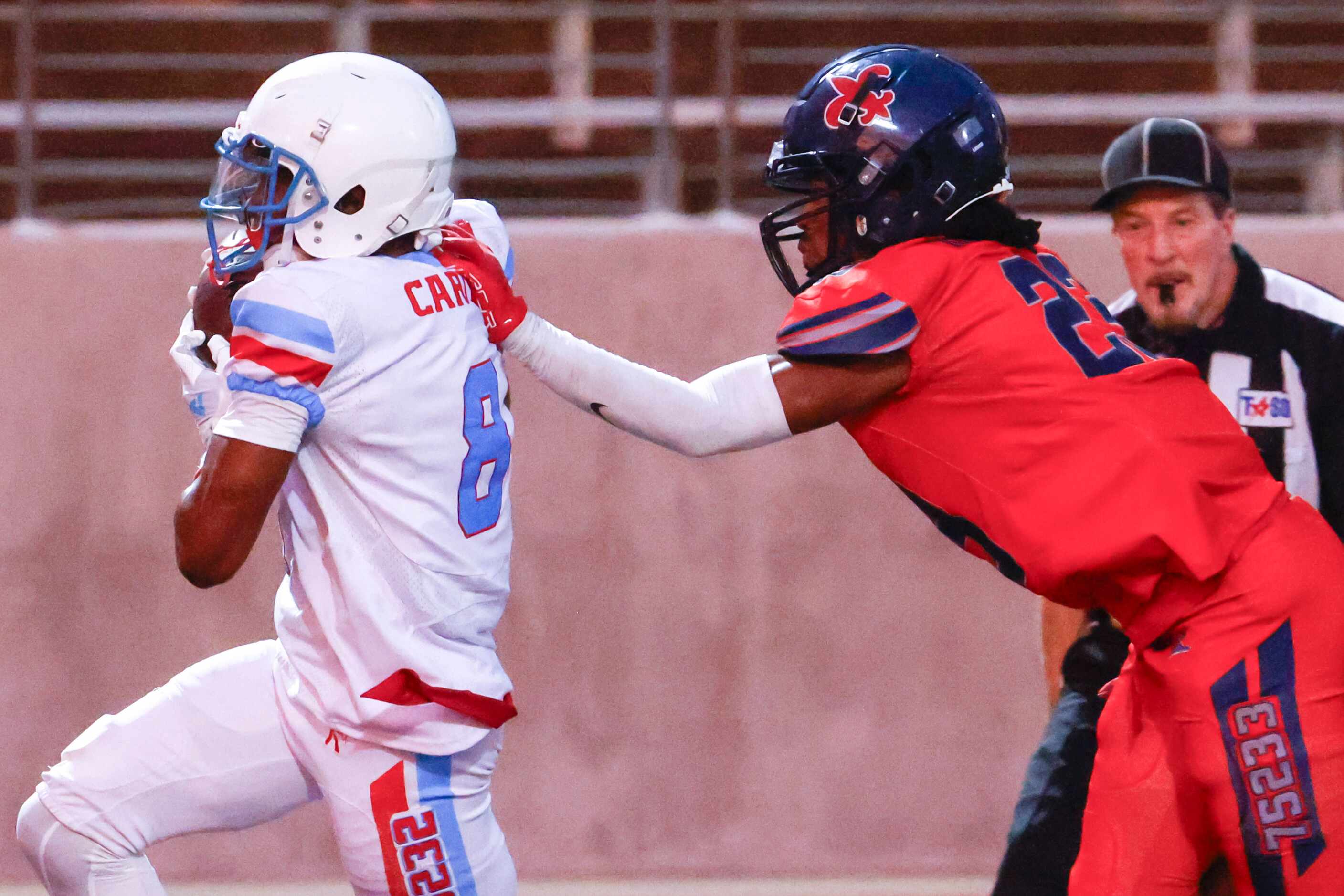 Carter High’s O’ryan Wallace (left) makes a touchdown as Kimball High’s BJ Shelby reaches to...