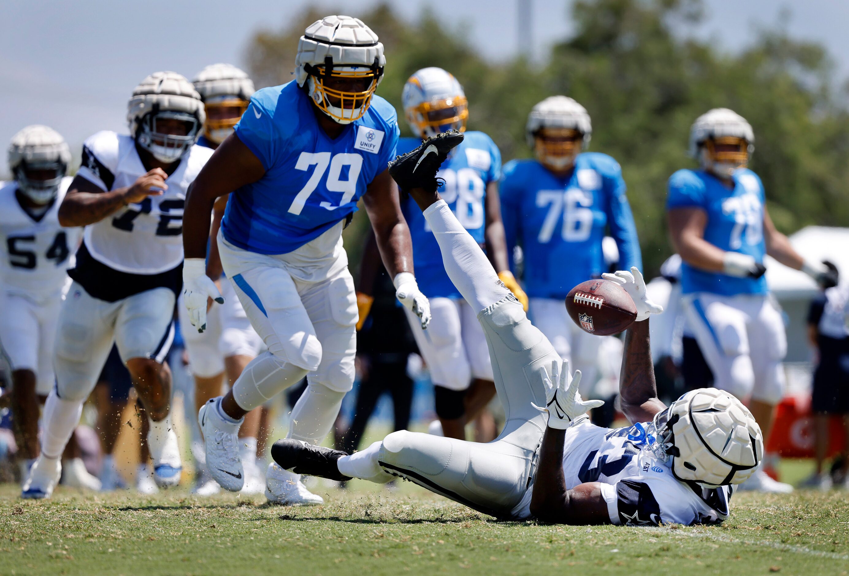 Dallas Cowboys defensive end Tarell Basham (93) makes an interception as he was falling the...