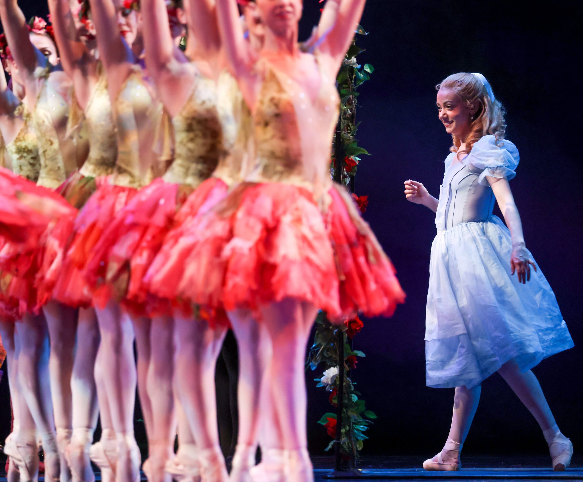 Alice (Alexandra F. Light, right) walks through the rose garden belonging to the Queen of...