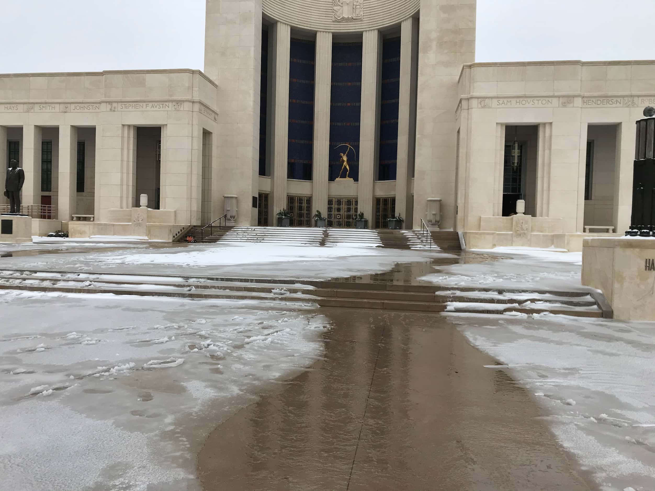 Water flows from the entrance at the Hall of State in Dallas on Feb. 17, 2021. The building...