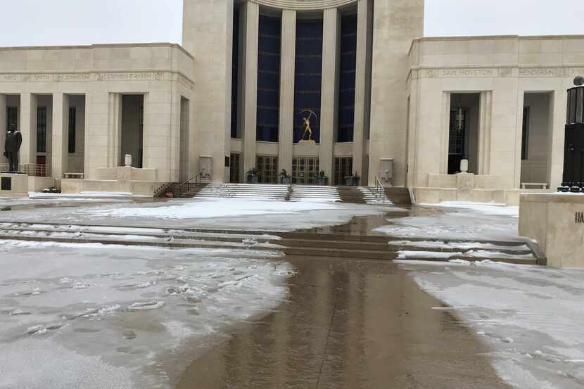Water flows from the entrance at the Hall of State in Dallas on Feb. 17, 2021. The building...