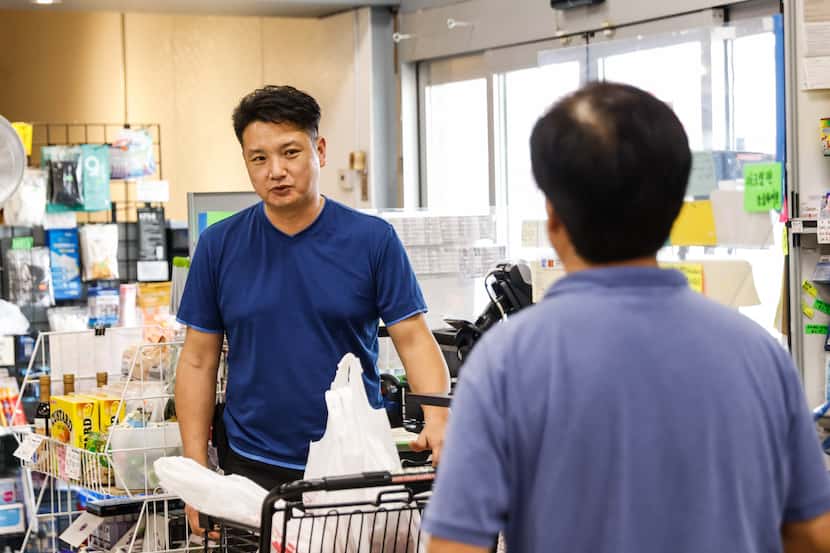 Rich Kim, owner of Shin Chon Market and Food Court, talks with a costumer in Dallas on...