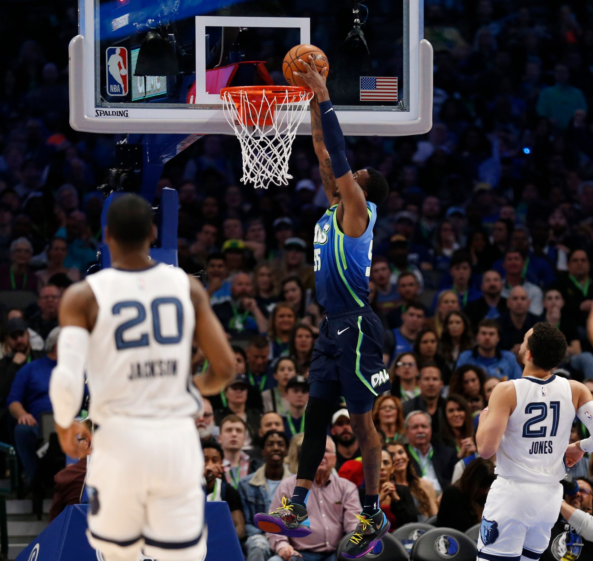 Dallas Mavericks guard Delon Wright (55) dunks the ball as Memphis Grizzlies guard Tyus...