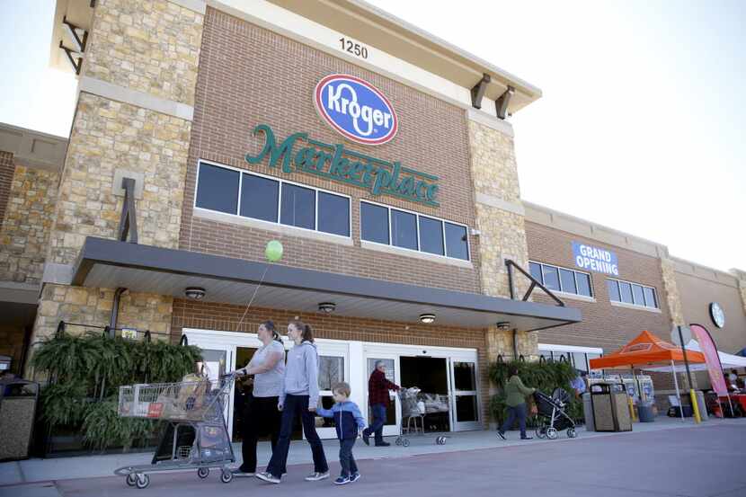 Shoppers walk through the entrance of the new Kroger Marketplace in Prosper, Texas on March...