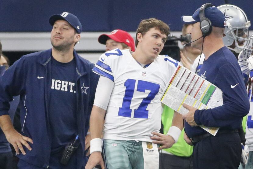 Dallas Cowboys quarterback Kellen Moore (17) leaves the field and walks past injured...