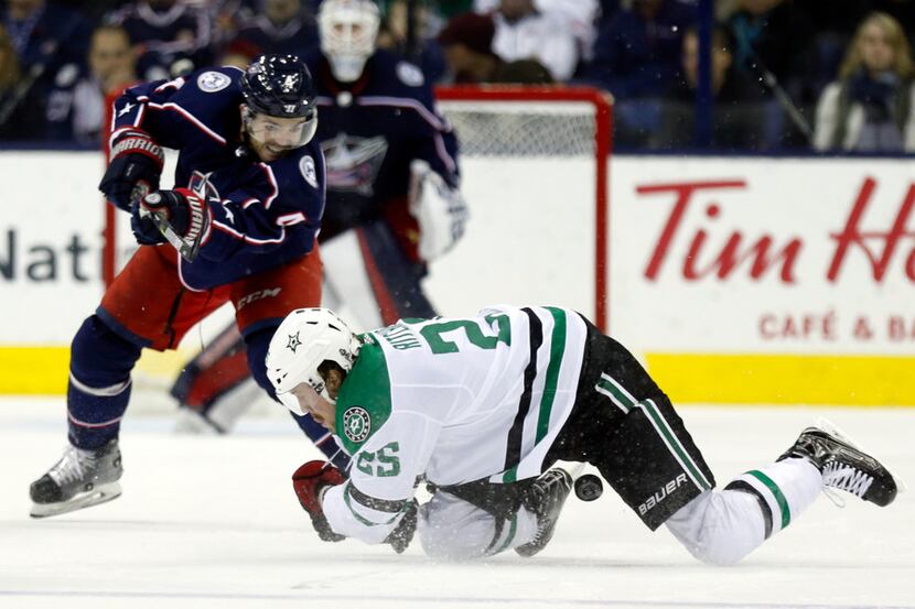 Dallas Stars forward Brett Ritchie, right, falls on the puck in front of Columbus Blue...
