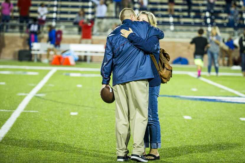 Allen head coach Tom Westerberg gets a hug from his wife Sandra after a win over Hebron in a...