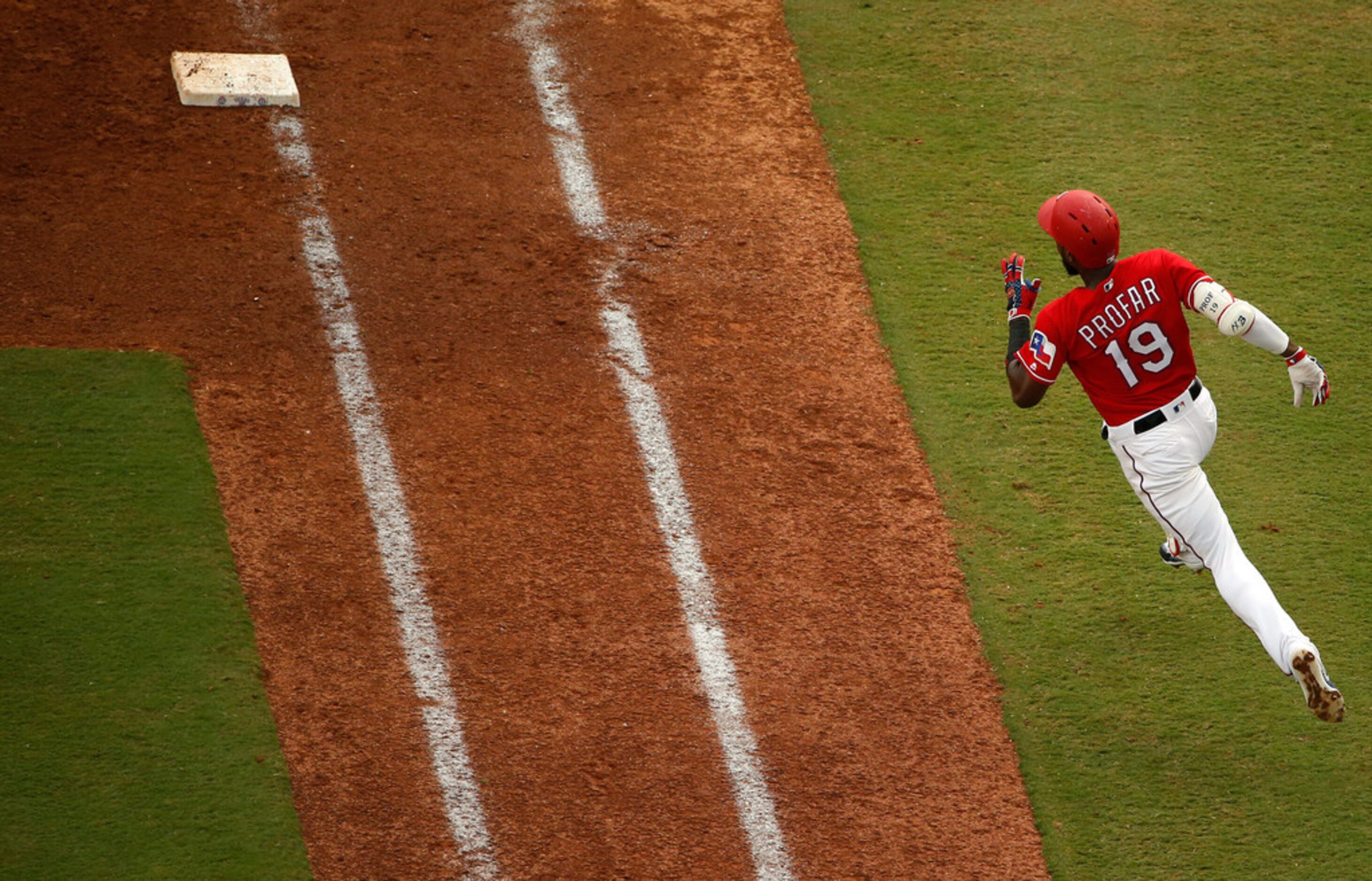 ARLINGTON, TX - AUGUST 19: Jurickson Profar #19 of the Texas Rangers rounds first base on...