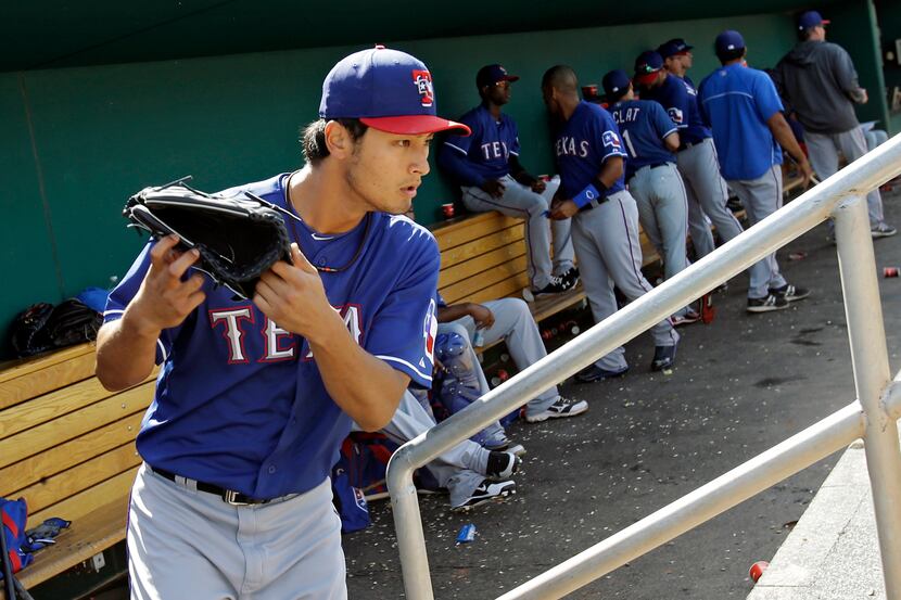 Texas Rangers starting pitcher Yu Darvish leaves the dugout to start the bottom of the fifth...