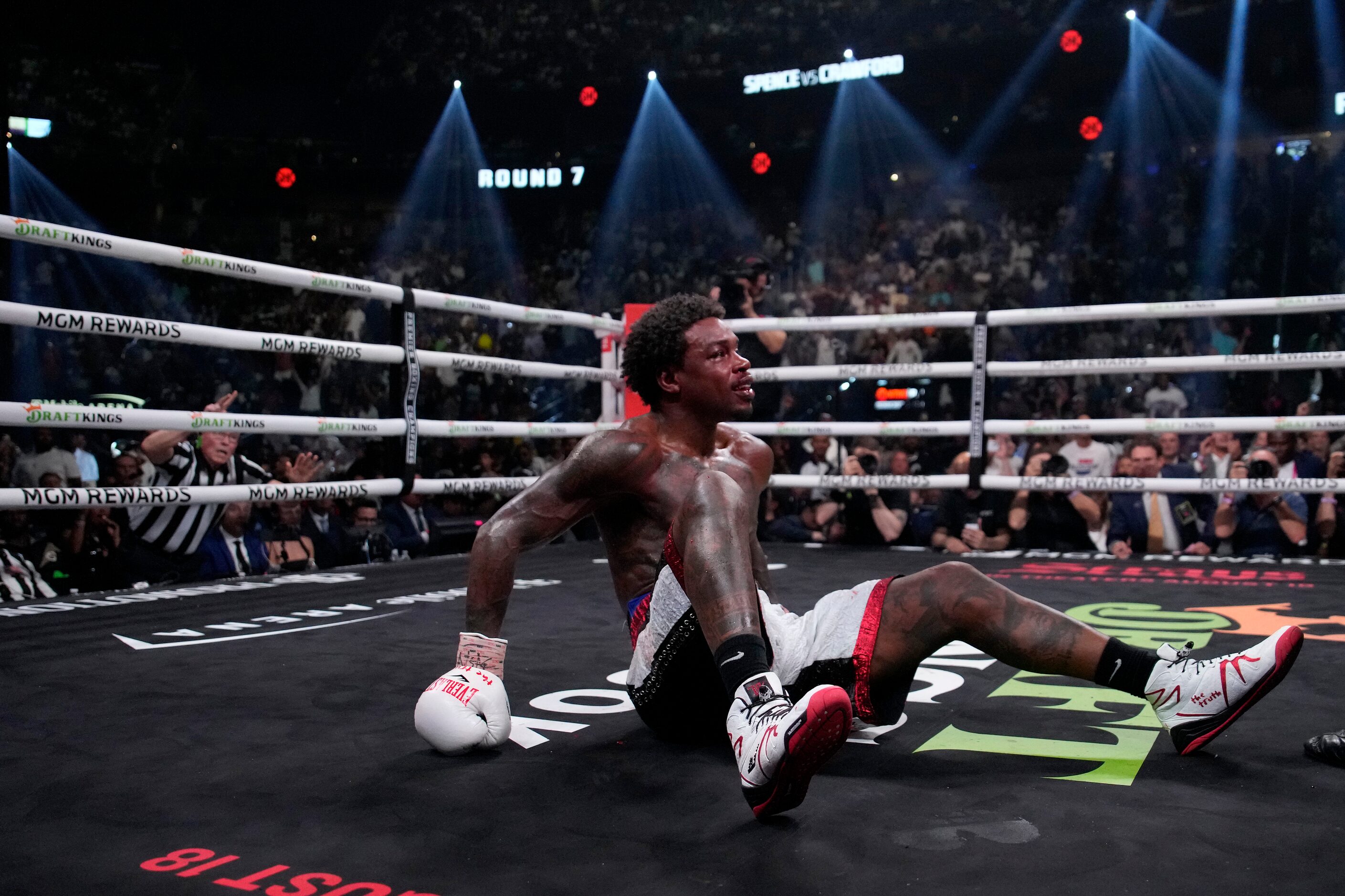 Errol Spence Jr., right, sits on the mat after being knocked down by Terence Crawford during...