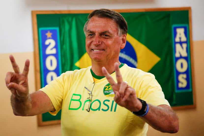 Brazilian President Jair Bolsonaro, who is running for another term, makes the victory sign...