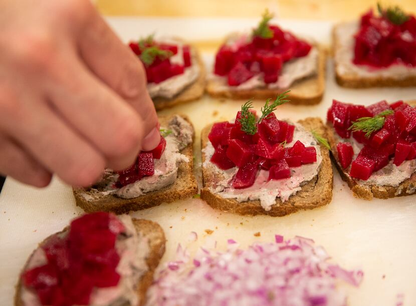 Chef Juan Laugerud prepares a duck liver pate topped with pickled beets and dill.