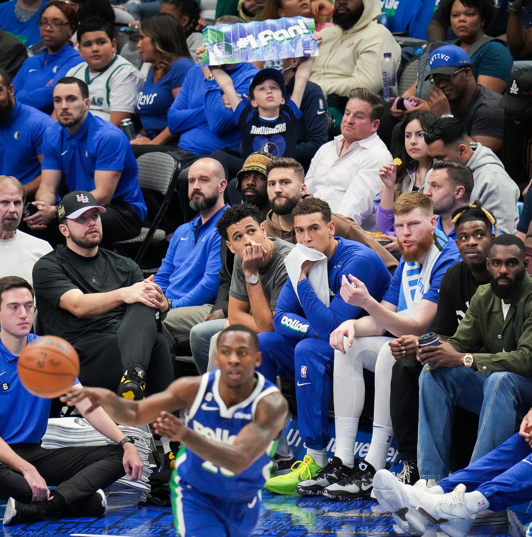 Dallas Mavericks guard Luka Doncic (at left with baseball hat), guard Kyrie Irving (in back...