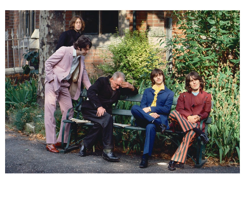 On a bench at St Pancras Coroner's Court, the Beatles posed around a man who fell asleep...