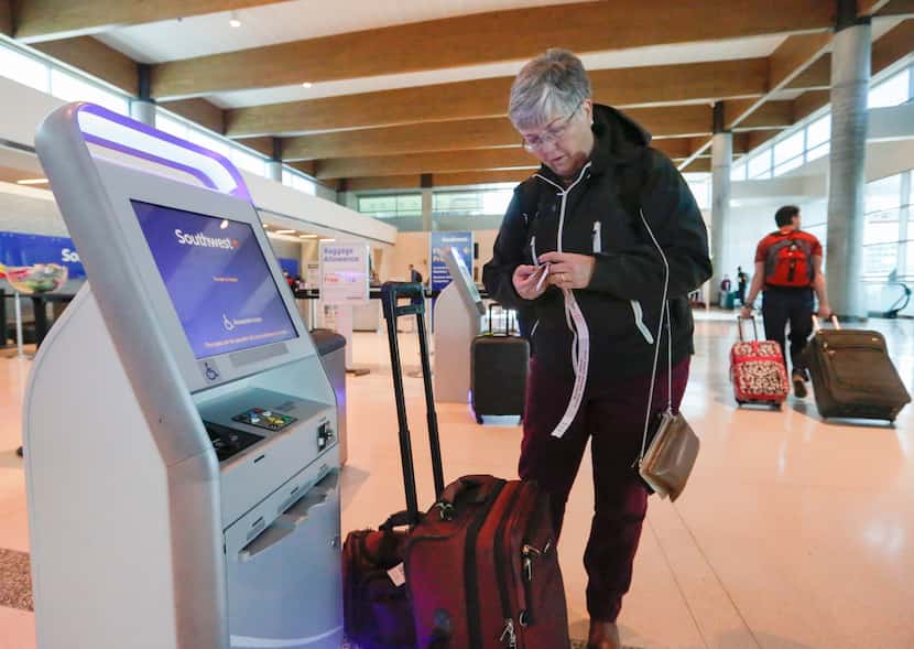 Ann Allen uses a Southwest Airlines kiosk to print luggage tags at Dallas Love Field...