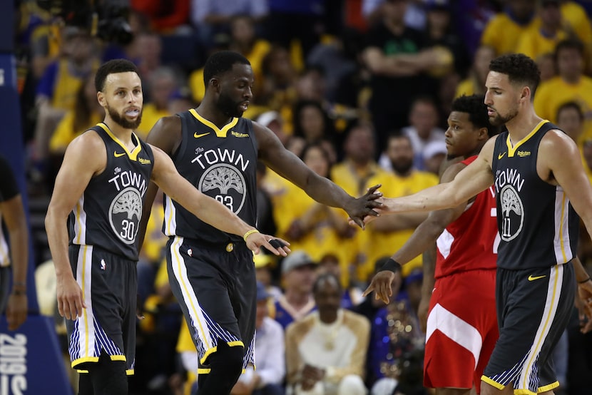 OAKLAND, CALIFORNIA - JUNE 07:  Stephen Curry #30, Draymond Green #23 and Klay Thompson #11...