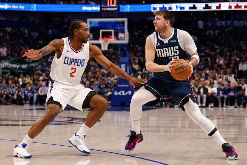 LA Clippers forward Kawhi Leonard (2) defends Dallas Mavericks guard Luka Doncic (77) during...