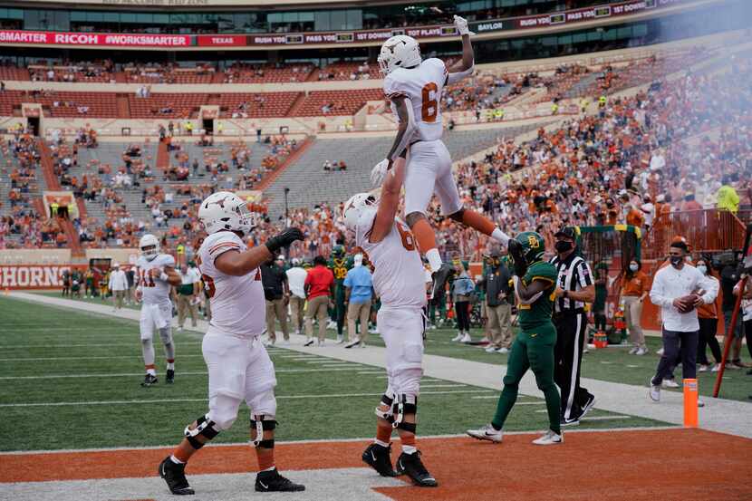 Texas' Joshua Moore (6) celebrates his touchdown catch with teammates against Baylor during...