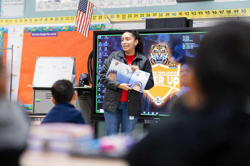 Patricia Salazar of Toyota reads to students at a bilingual elementary school in Lancaster ISD.