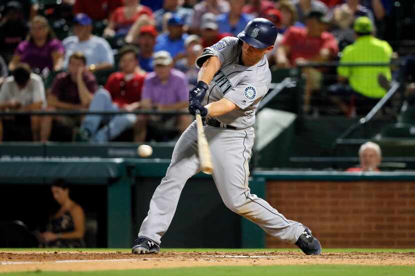 Seattle Mariners' Kyle Seager swings at pitch from the Texas Rangers during a baseball game,...