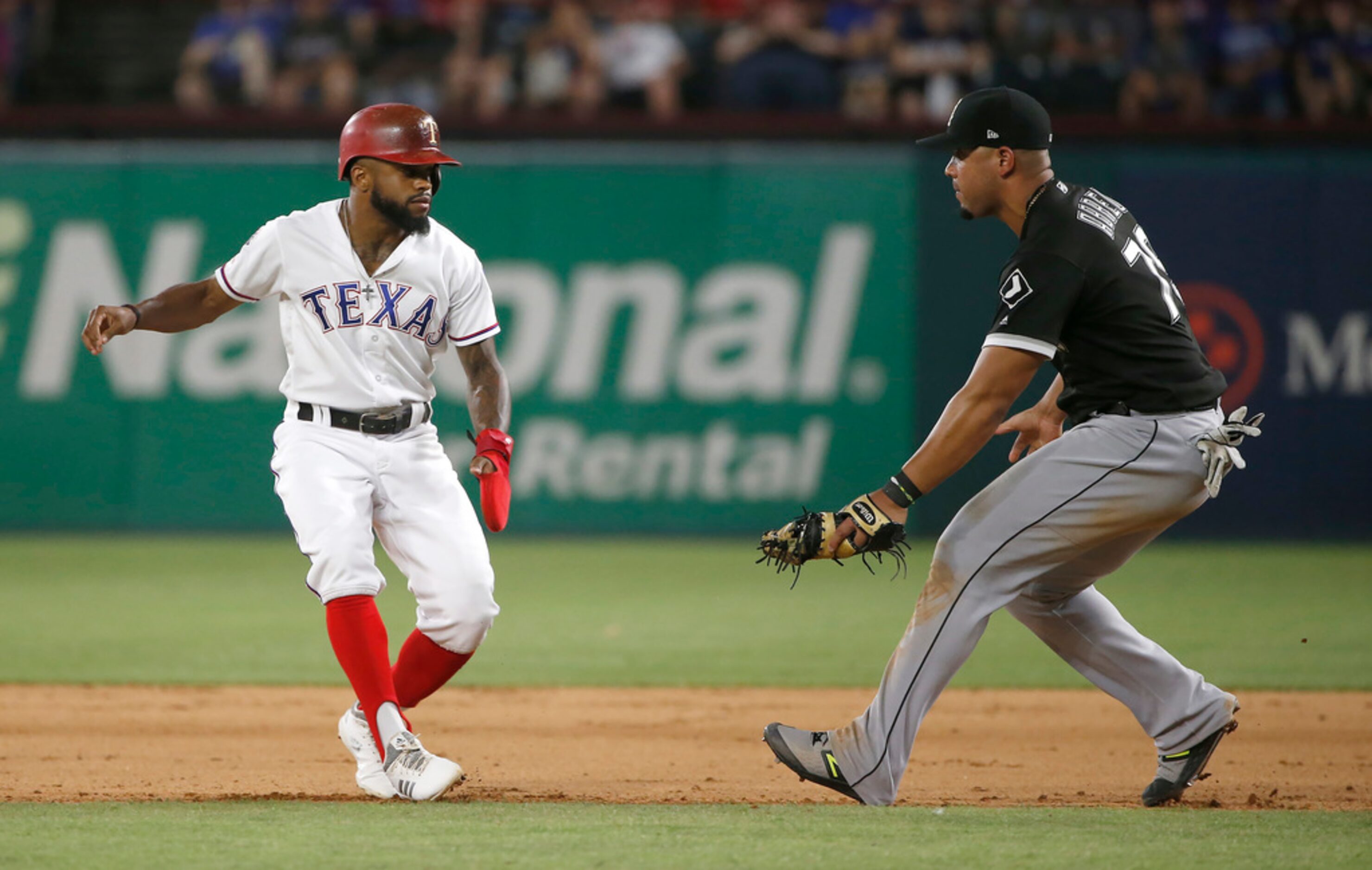 ARLINGTON, TX - JUNE 21: Delino DeShields #3 of the Texas Rangers is caught in a rundown by...