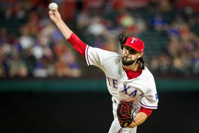 Texas Rangers relief pitcher Tony Barnette pitches during the eighth inning of a 9-3 victory...