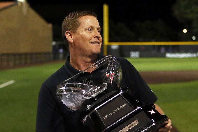 Texas Tech athletic director Kirby Hocutt holds the Big 12 Conference championship trophy...