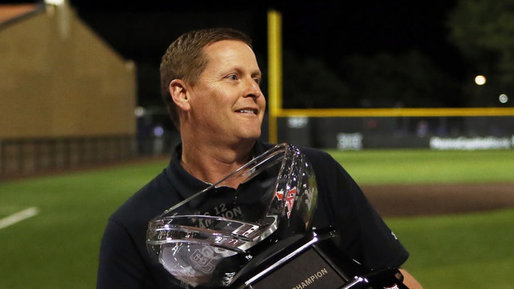 Texas Tech athletic director Kirby Hocutt holds the Big 12 Conference championship trophy...