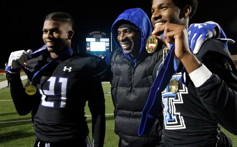 TC-Cedar Hill assistant coach Deion Sanders poses with his sons Shilo Sanders (21) and...