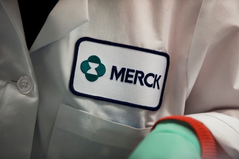 In this Thursday, Feb. 28, 2013 photo, a Merck logo is placed on scientist's lab coat in...