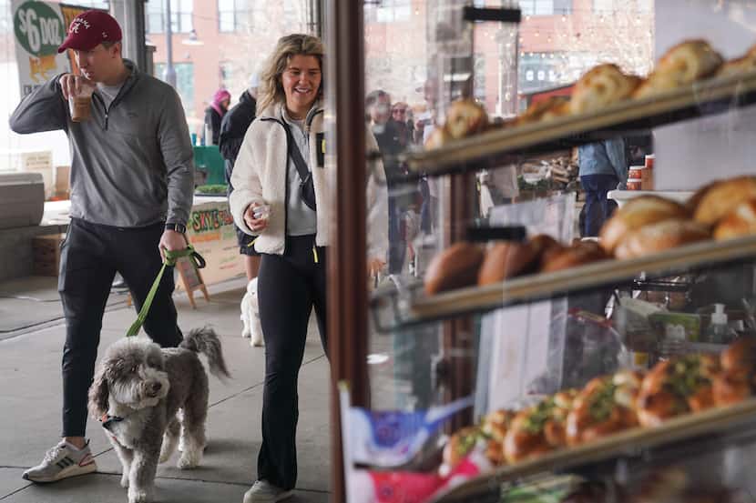 Jake Dumbar and Rayanna O’Rourke, walk through The Shed with their dog Willie at the Dallas...