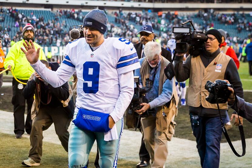 Dallas Cowboys quarterback Tony Romo waves to fans as he walks off the field after a loss to...
