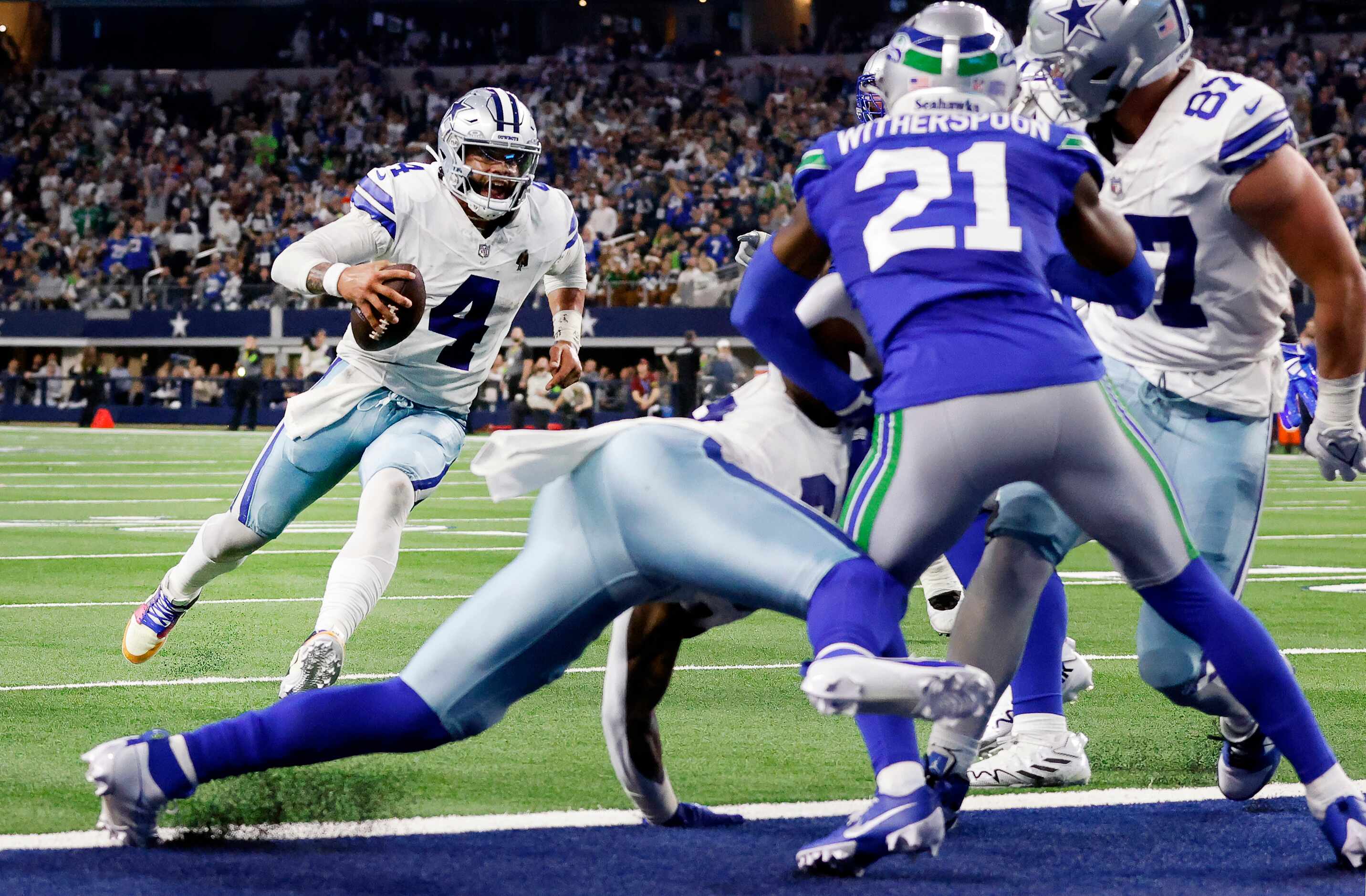 Dallas Cowboys quarterback Dak Prescott (4) races for the end zone as he gets blocking up...