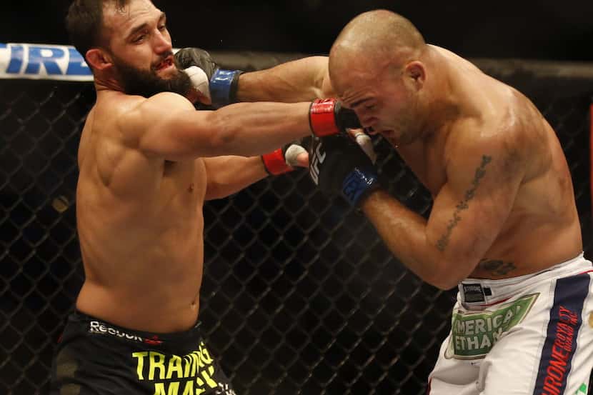 Johny Hendricks (red gloves) fights Robbie Lawler (blue) for the  UFC World Welterweight...