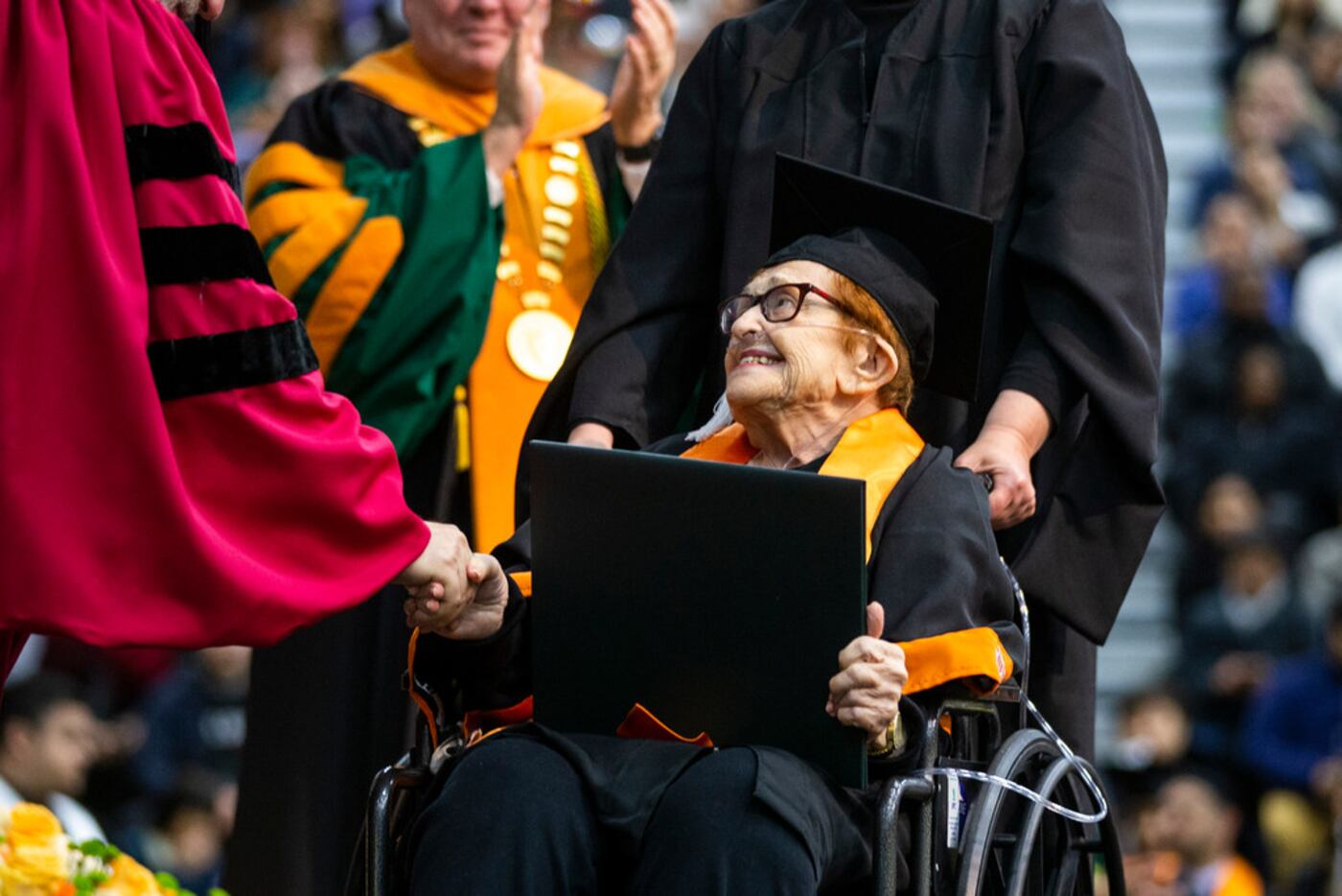 Janet Fein, 84, beamed as she crosses the stage during a commencement ceremony at UT Dallas...