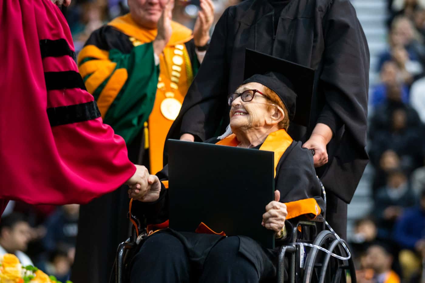 Janet Fein, 84, beamed as she crosses the stage during a commencement ceremony at UT Dallas...