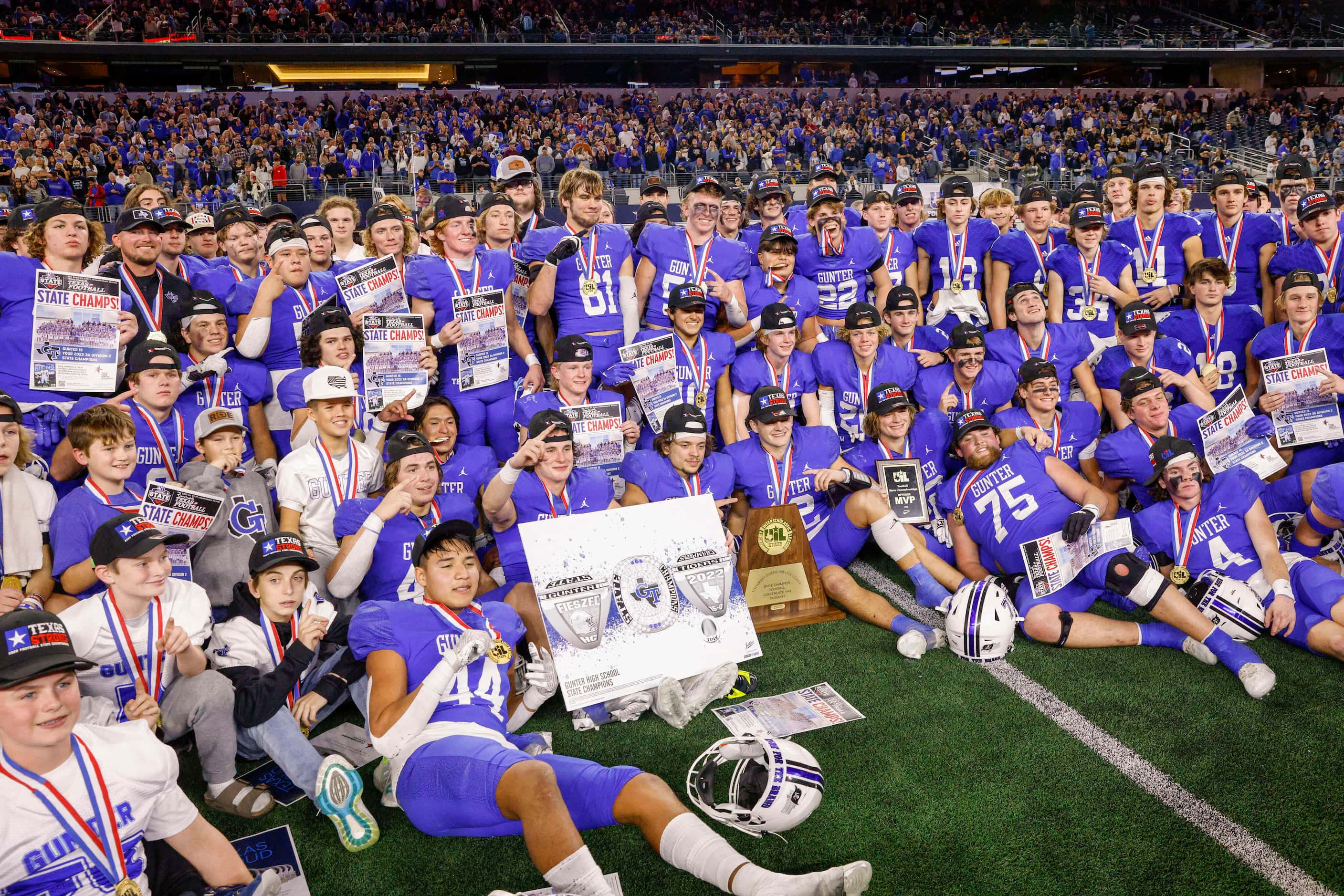 Gunter players pose after winning the Class 3A Division II state championship game at AT&T...